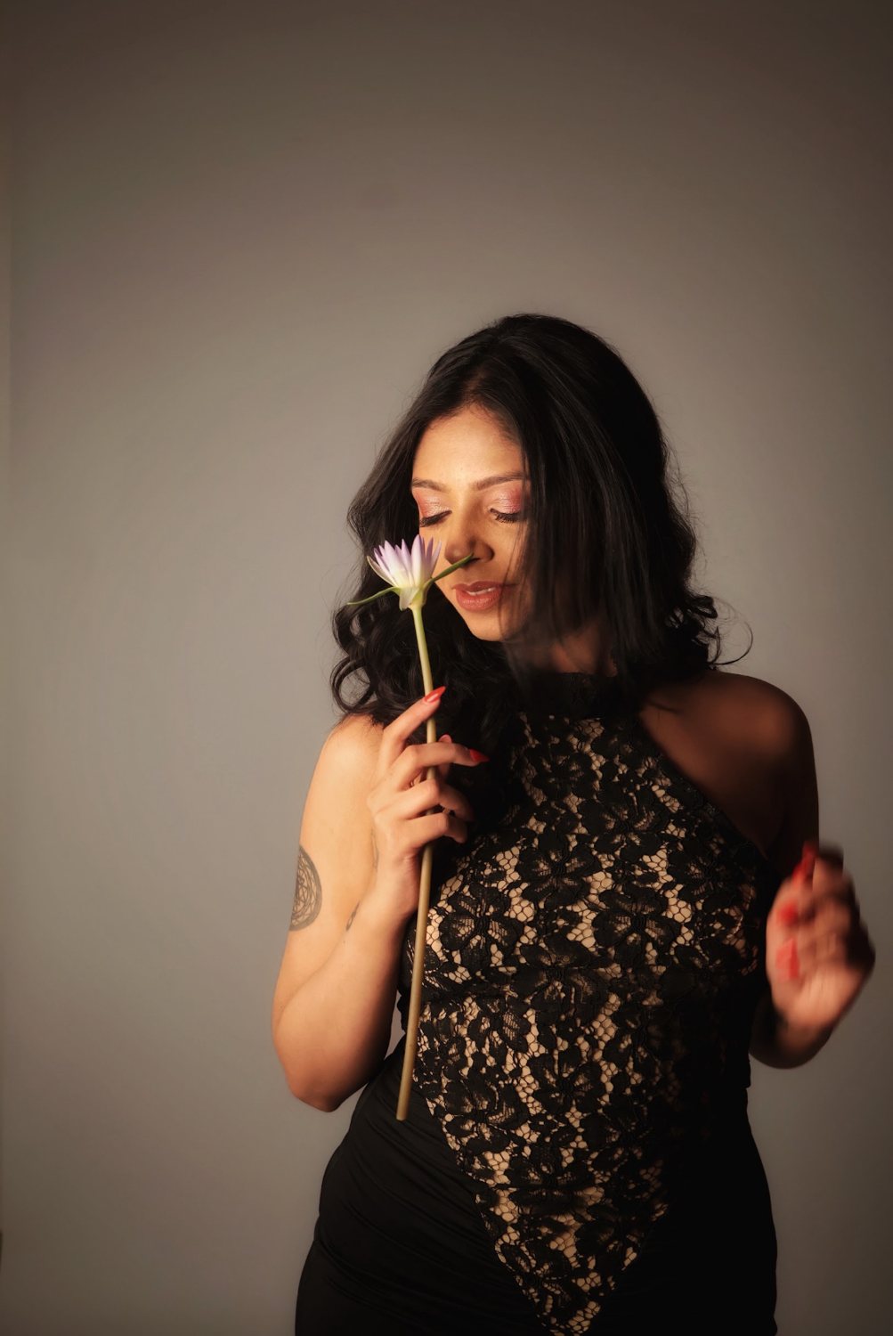 Mrunalini holding a water lily, softly lit